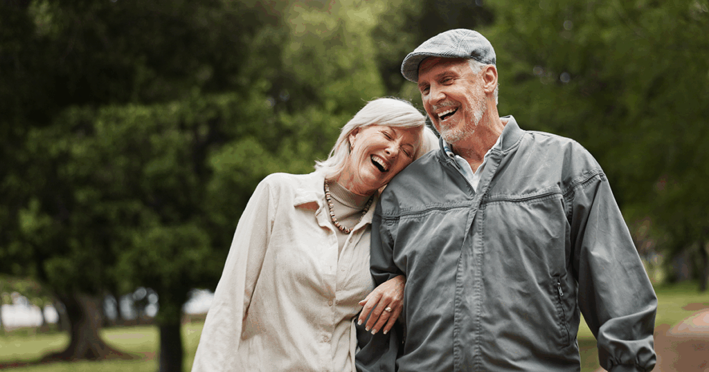 Older jovial couple outside