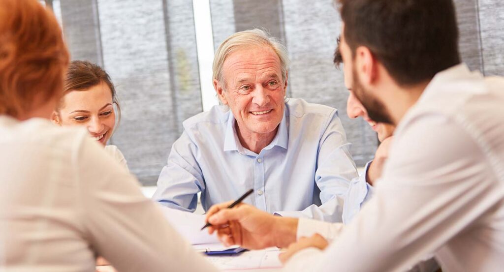 Mature businessman works with his succession planning advisors